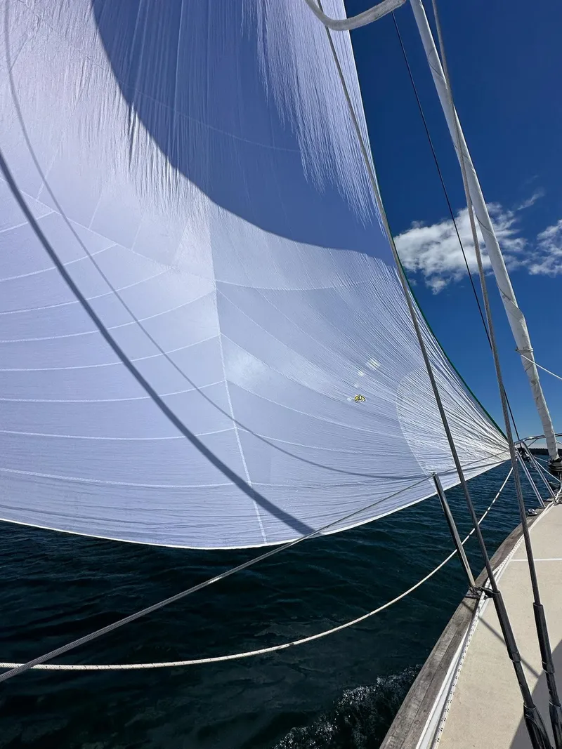 Slide: The Image of Sailing on a 2014 Tartan Fantail with white sails against a clear blue sky. - 6