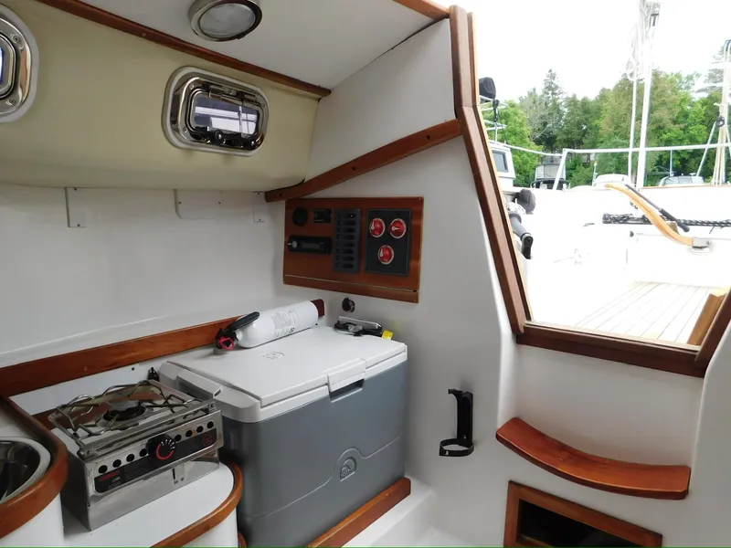 Slide: The Image of Interior of 2014 Tartan Fantail sailboat with compact kitchen and control panel. - 7