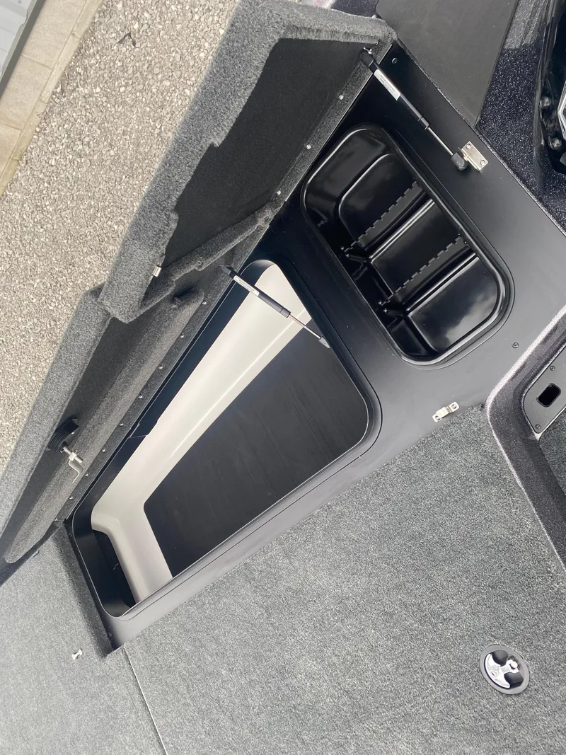 Slide: The Image of 2025 Skeeter ZXR 21 SE boat storage compartment with open lid and organized interior. - 10
