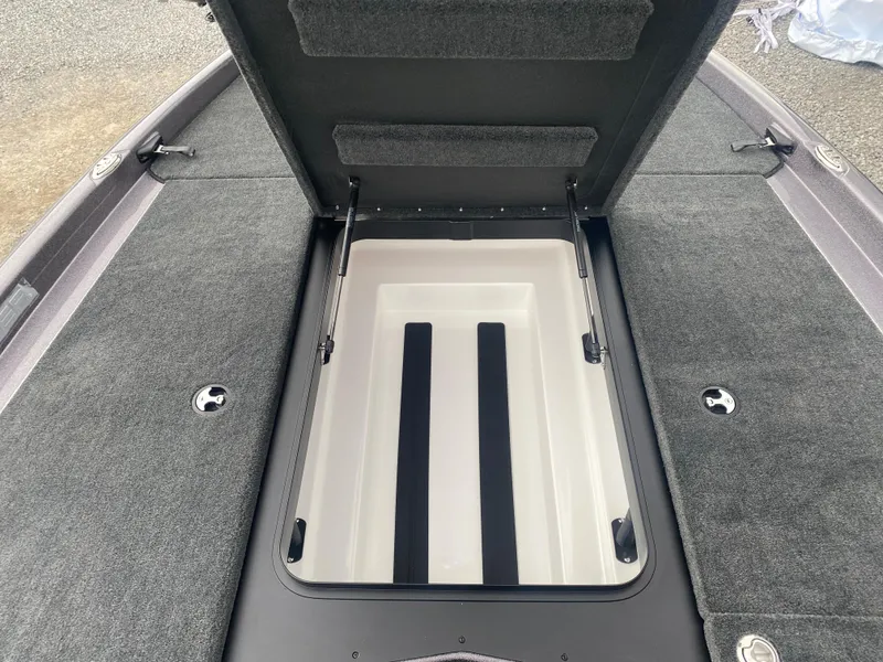 Slide: The Image of 2025 Skeeter ZXR 21 SE boat storage compartment with open lid, showcasing interior space. - 11