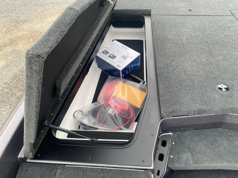 Slide: The Image of Storage compartment in a 2025 Skeeter ZXR 21 SE boat with accessories and wiring. - 12
