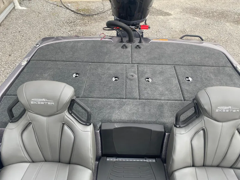 Slide: The Image of 2025 Skeeter ZXR 21 SE boat interior with gray seats and carpeted deck. - 13