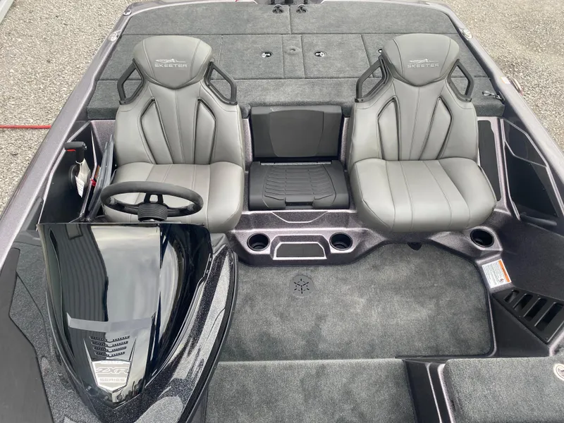 Slide: The Image of 2025 Skeeter ZXR 21 SE boat interior with dual gray seats and steering console. - 9