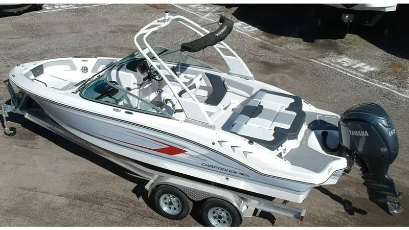 Slide: The Image of 2024 Chaparral 21 SSi OB boat on trailer, featuring sleek design and Yamaha outboard motor. - 2