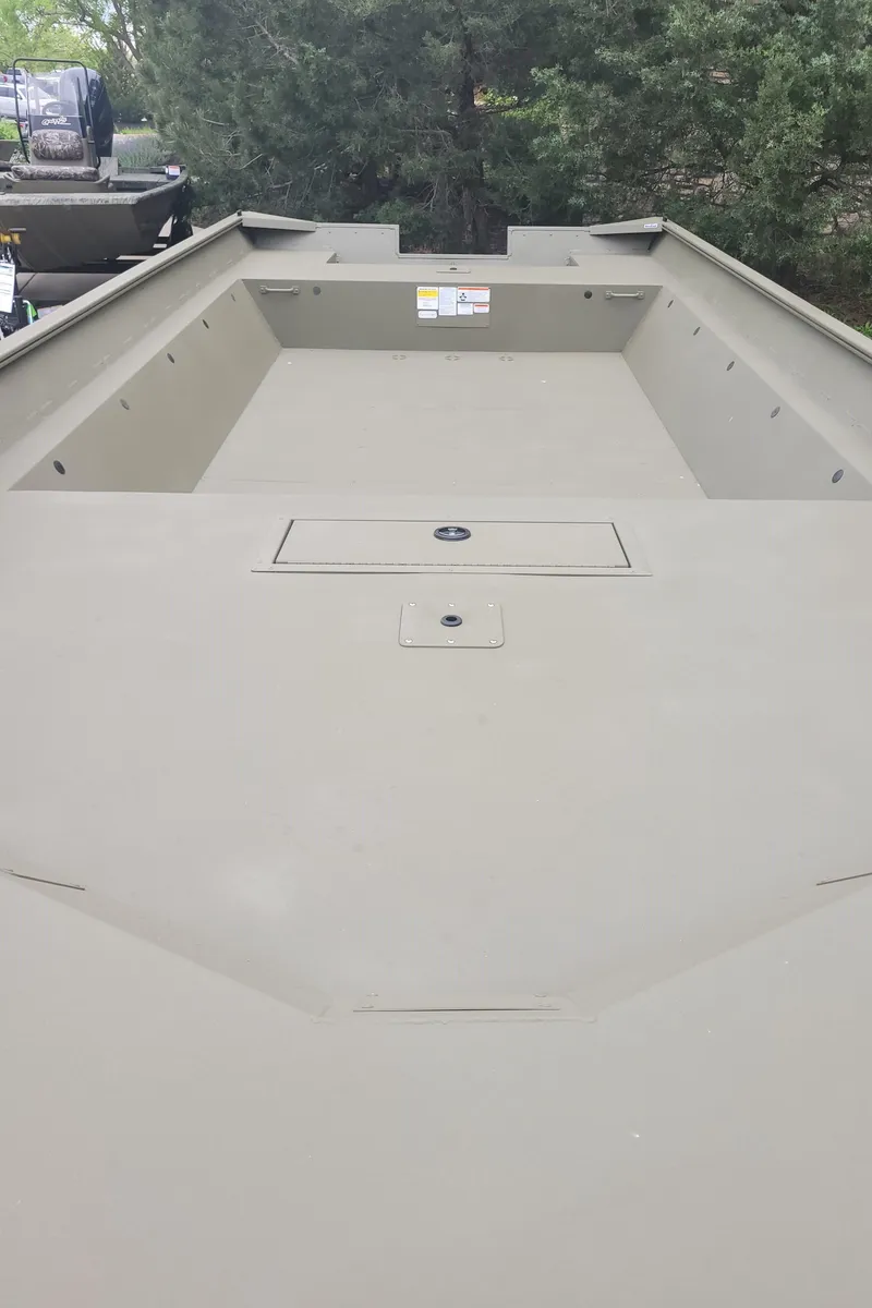 Slide: The Image of 2025 Tracker 2072AWL boat interior with spacious deck and storage compartments. - 2