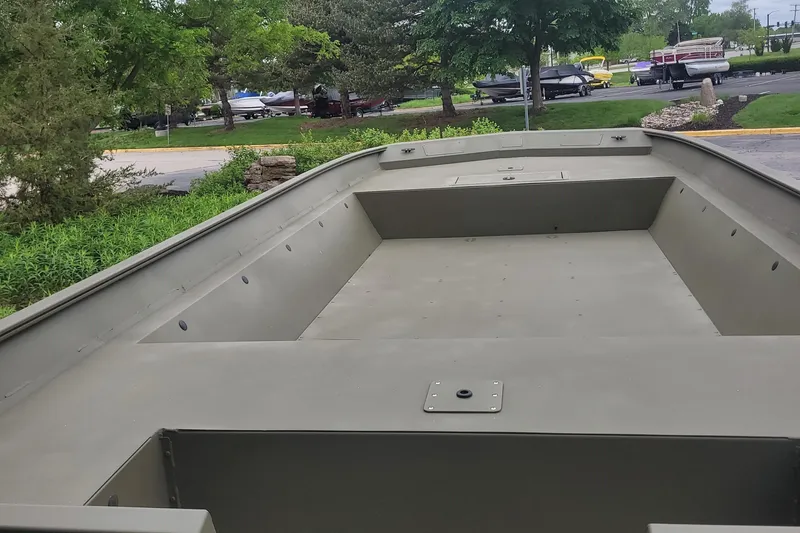 Slide: The Image of 2025 Tracker 2072AWL boat, empty interior view, parked outdoors. - 3