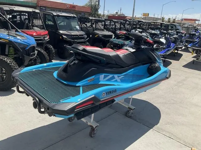 Slide: The Image of 2024 Yamaha Waverunner VX Deluxe with Audio, blue and black, displayed outdoors. - 3