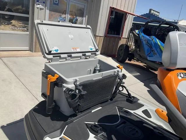 Slide: The Image of 2024 Sea-Doo Waverunner Fishpro™ Trophy 170 with open storage compartment, parked outdoors. - 6