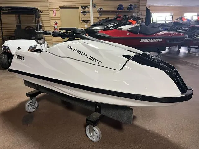 Slide: The Image of 2025 Yamaha Waverunner Superjet® in showroom, sleek white design on display stand. - 2