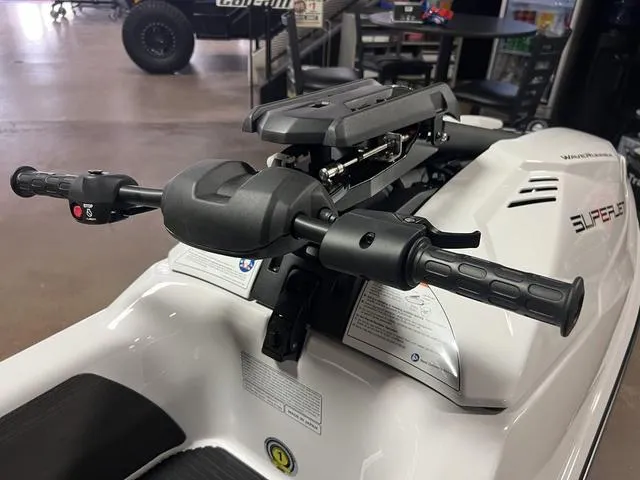 Slide: The Image of 2025 Yamaha Waverunners Superjet® handlebars in showroom, showcasing sleek design and controls. - 4