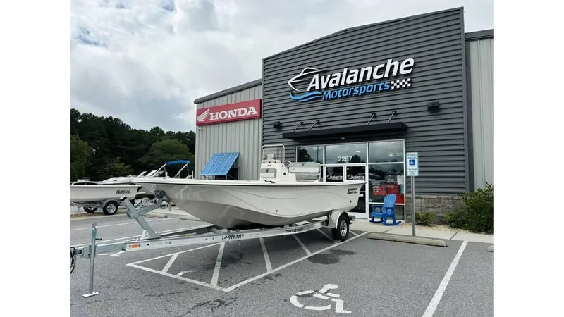 The Image of 2025 Carolina Skiff 21 LS boat on trailer at Avalanche Motorsports dealership. - 1