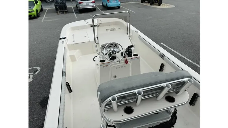 Slide: The Image of 2025 Carolina Skiff 21 LS boat interior with steering console, parked in a lot. - 15