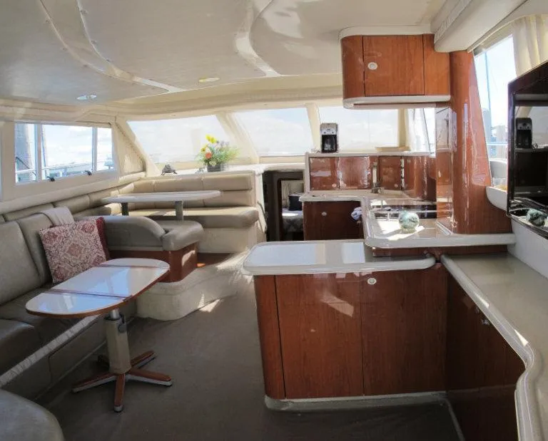 Slide: The Image of Luxurious interior of a 1998 Sea Ray 480 Sedan Bridge yacht with elegant furnishings. - 1