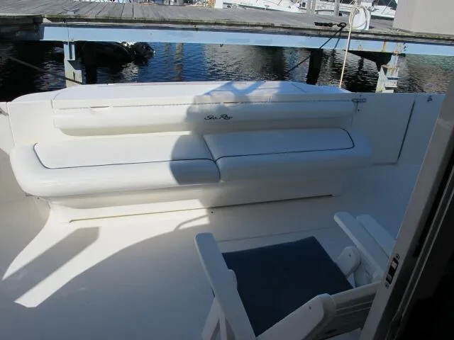 Slide: The Image of 1998 Sea Ray 480 Sedan Bridge yacht with white seating on deck. - 11