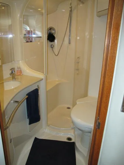 Slide: The Image of Bathroom interior of 1998 Sea Ray 480 Sedan Bridge yacht, featuring shower and toilet. - 12