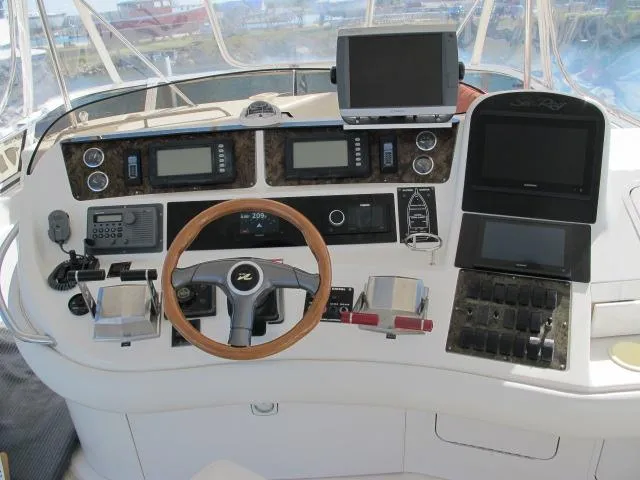 Slide: The Image of 1998 Sea Ray 480 Sedan Bridge helm with advanced navigation and control systems. - 15