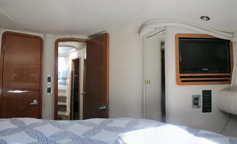 Slide: The Image of Interior cabin of 1998 Sea Ray 480 Sedan Bridge with TV and wooden doors. - 8