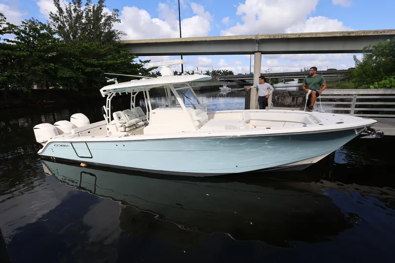 Slide: The Image of 2020 Cobia 350 Center Console boat docked on a sunny day. - 1