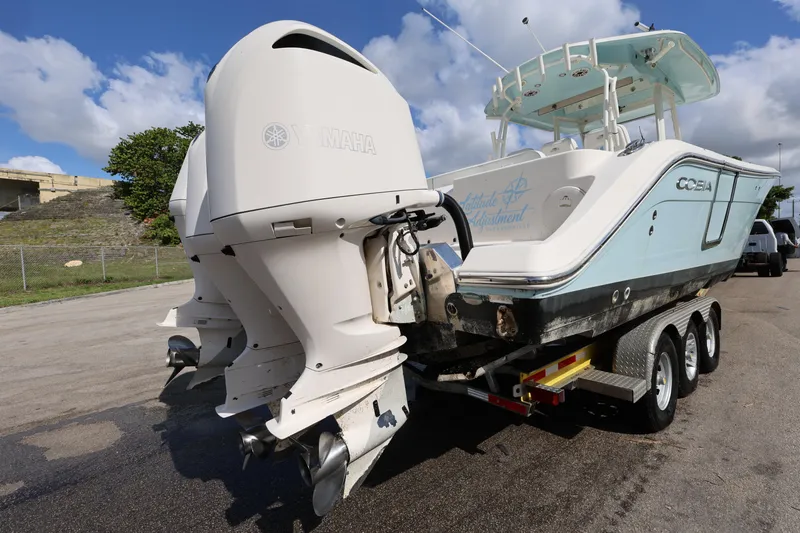 Slide: The Image of 2020 Cobia 350 Center Console boat on trailer with dual outboard engines. - 7