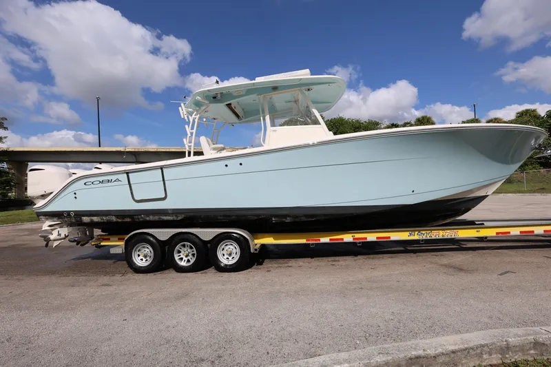 Slide: The Image of 2020 Cobia 350 Center Console boat on trailer under blue sky. - 8