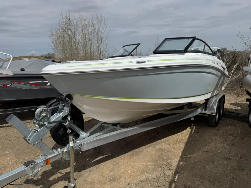 Slide: The Image of 2024 Tahoe 210 S boat on trailer in a storage facility. - 0