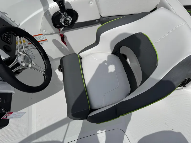 Slide: The Image of 2024 Tahoe 210 S boat interior with white and gray seating, green accents, and storage compartments. - 10