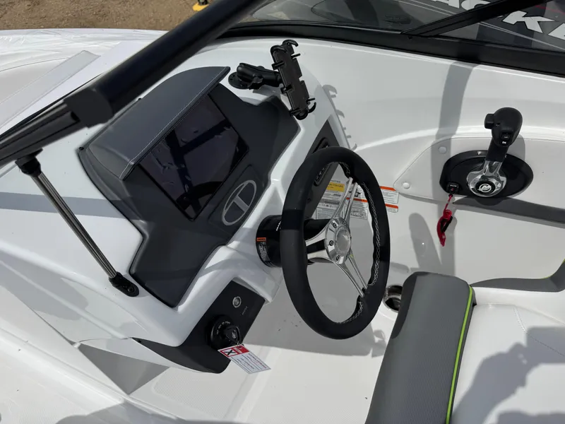 Slide: The Image of 2024 Tahoe 210 S boat interior with cushioned seating and cup holders. - 11