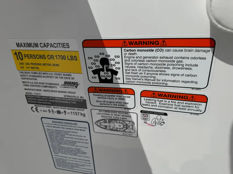 Slide: The Image of 2024 Tahoe 210 S boat interior with white and gray seating, green accents, and speaker. - 12