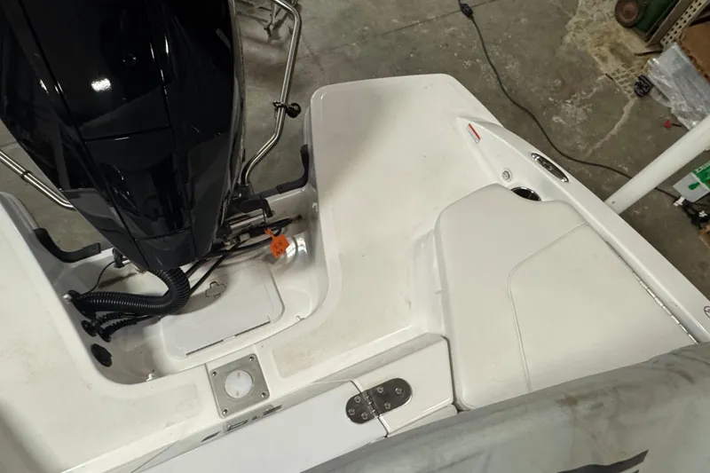 Slide: The Image of 2024 Tahoe 210 S boat engine and deck view in a garage setting. - 17