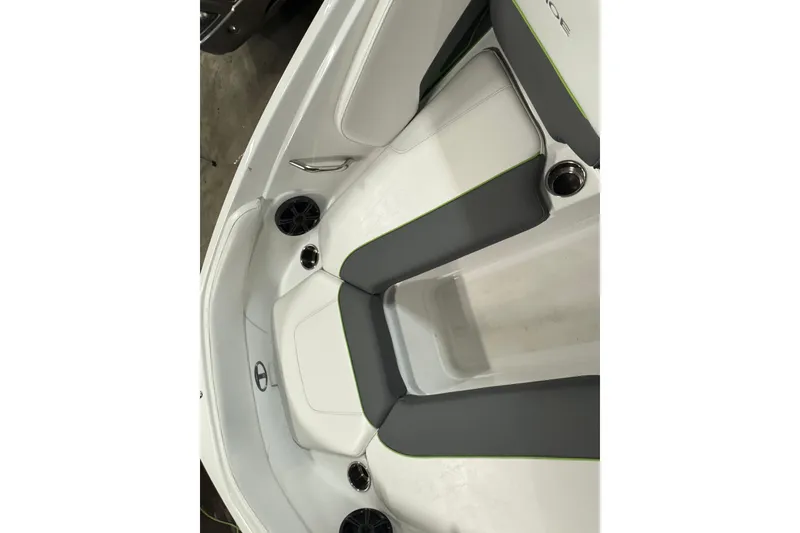 Slide: The Image of 2024 Tahoe 210 S boat interior with gray and white seating, cup holders, and speakers. - 20