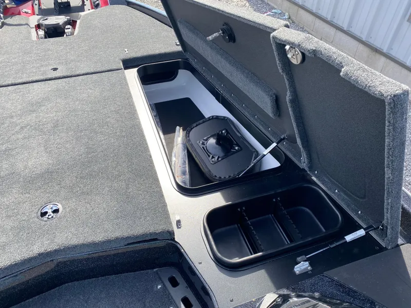 Slide: The Image of 2025 Skeeter ZXR 20 boat storage compartment with open lid and organized interior. - 11