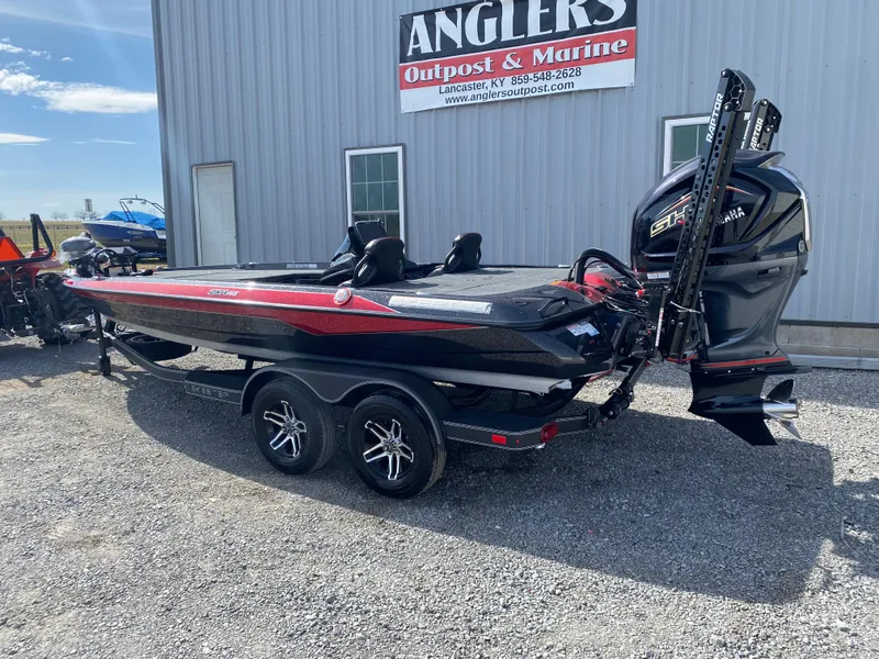 Slide: The Image of 2025 Skeeter ZXR 20 boat with dual motors, parked outside Angler's Outpost & Marine. - 5