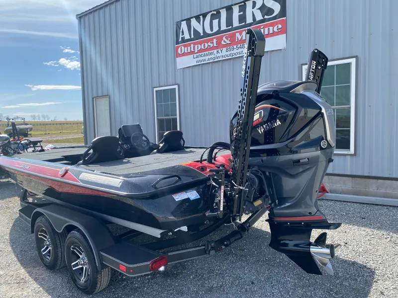 Slide: The Image of 2025 Skeeter ZXR 20 boat with powerful outboard motor, parked at Anglers Outpost & Marine. - 6