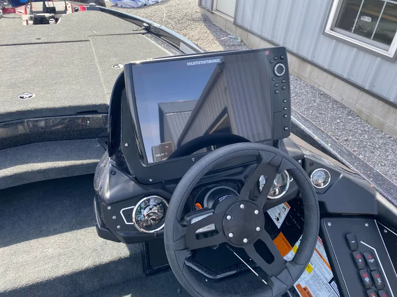 Slide: The Image of 2025 Skeeter ZXR 20 boat dashboard with steering wheel and Humminbird display. - 7
