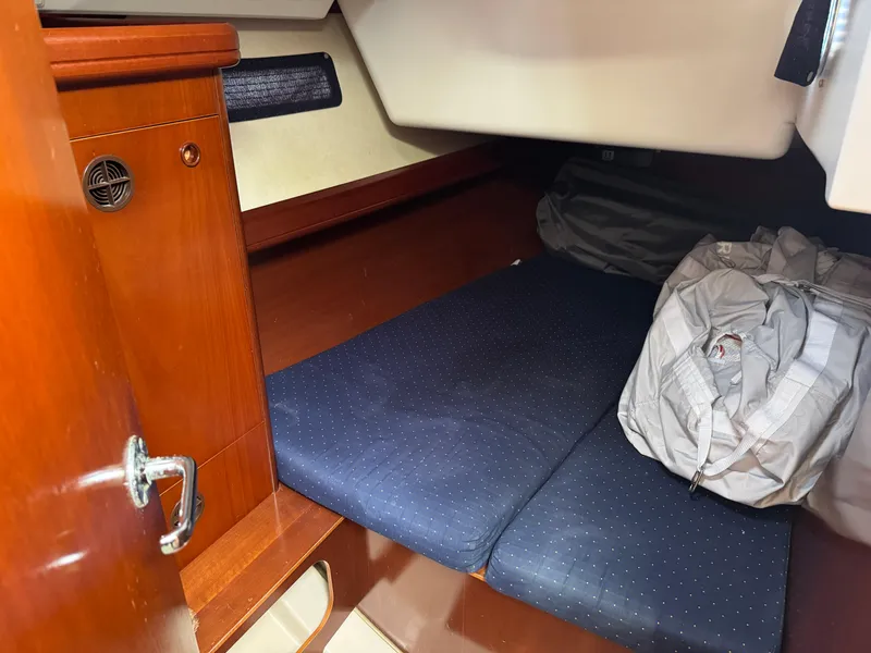 Slide: The Image of Cozy cabin interior of 2002 Beneteau Oceanis Clipper 393 sailboat with blue cushions. - 12