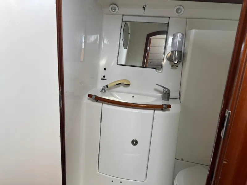 Slide: The Image of Bathroom interior of 2002 Beneteau Oceanis Clipper 393 yacht, featuring sink and mirror. - 16