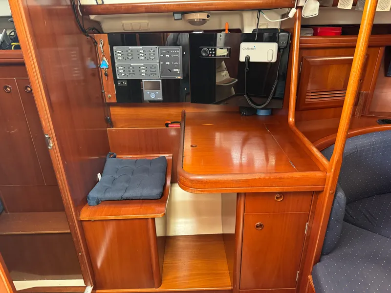 Slide: The Image of Interior of 2002 Beneteau Oceanis Clipper 393 yacht with navigation station and wooden cabinetry. - 17