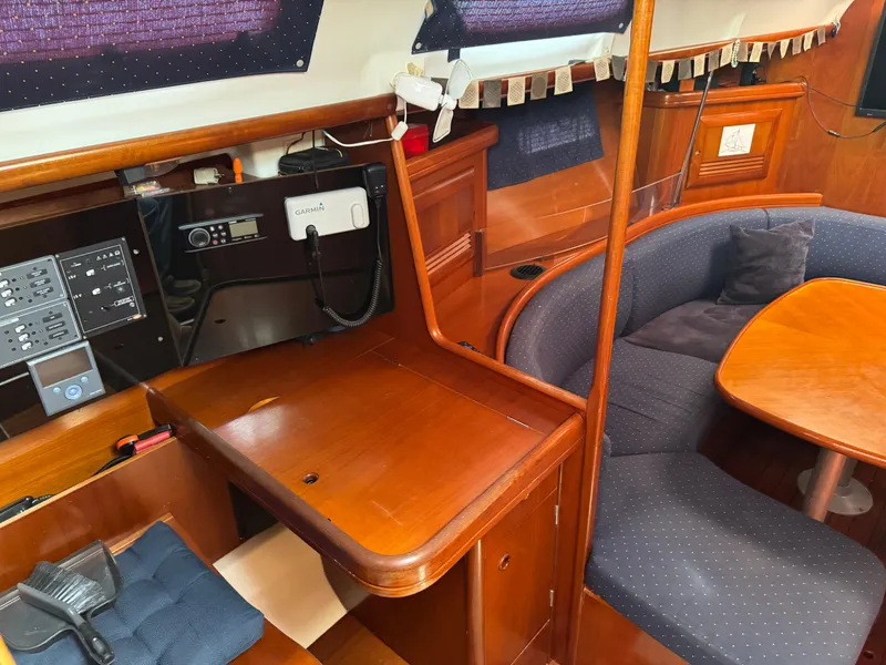 Slide: The Image of Interior of 2002 Beneteau Oceanis Clipper 393 with navigation station and seating area. - 23