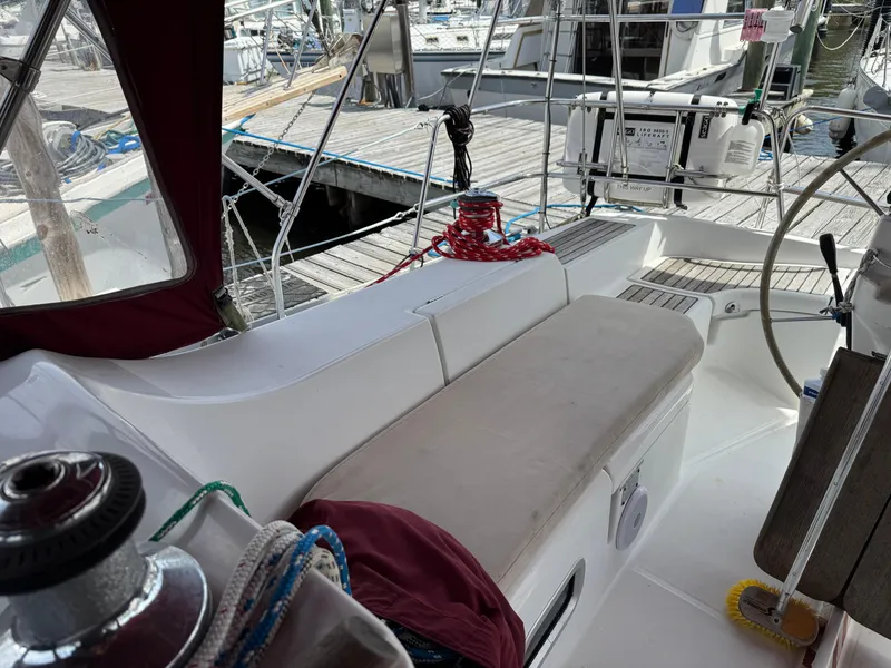 Slide: The Image of Cockpit of 2002 Beneteau Oceanis Clipper 393 sailboat, featuring seating and steering wheel. - 24