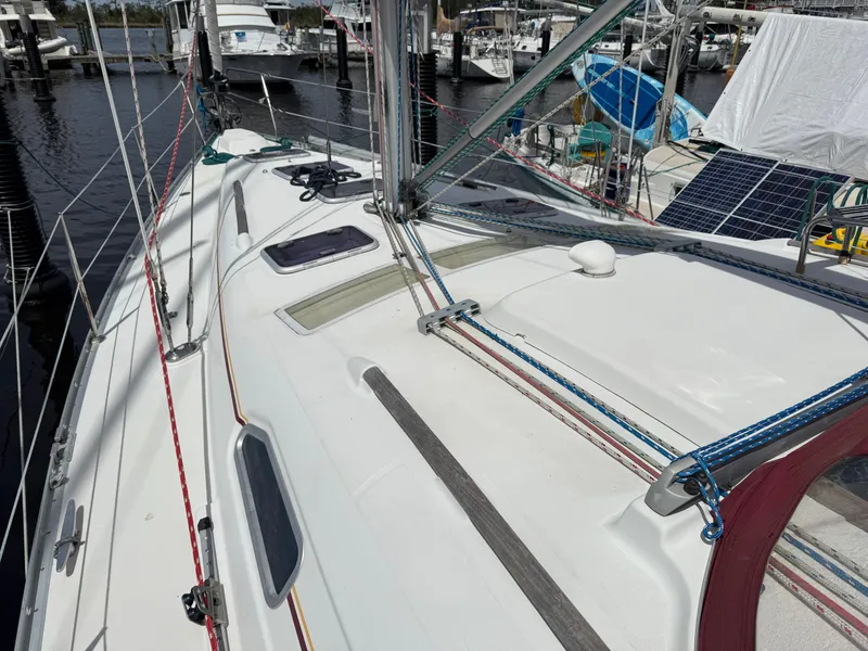 Slide: The Image of 2002 Beneteau Oceanis Clipper 393 sailboat deck with rigging and marina background. - 28