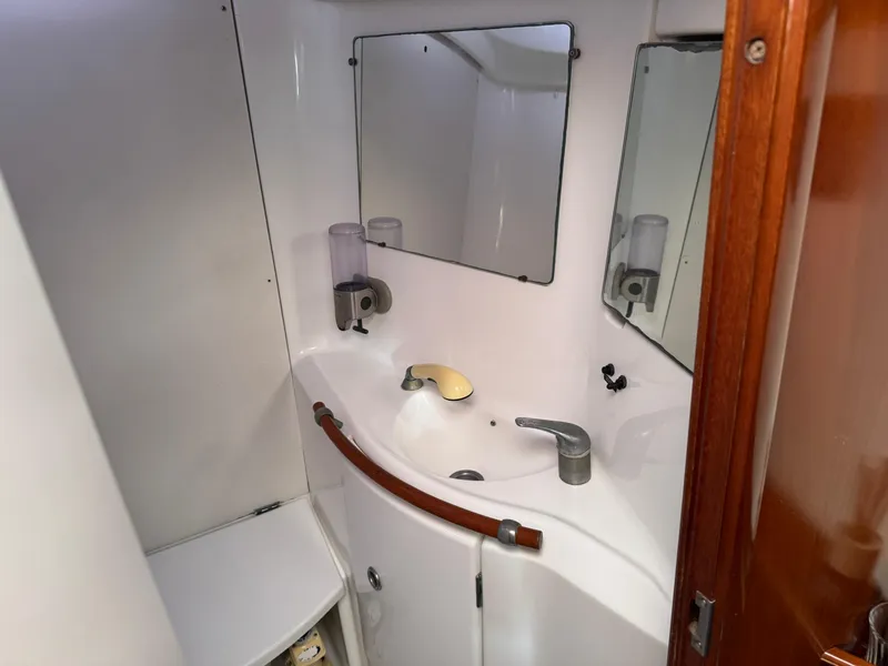 Slide: The Image of Bathroom interior of 2002 Beneteau Oceanis Clipper 393 yacht, featuring sink and mirror. - 7