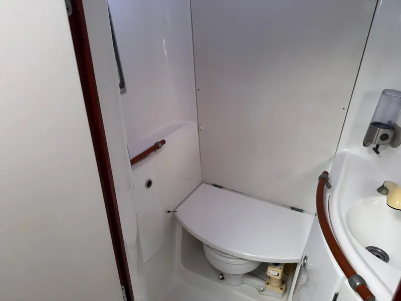 Slide: The Image of Bathroom interior of 2002 Beneteau Oceanis Clipper 393 yacht, featuring compact toilet and sink. - 8