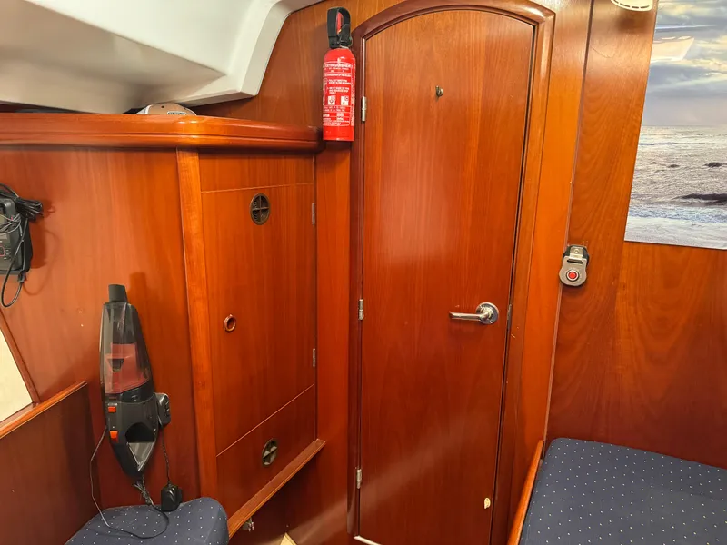 Slide: The Image of Interior of 2002 Beneteau Oceanis Clipper 393 yacht with wooden cabinetry and fire extinguisher. - 9