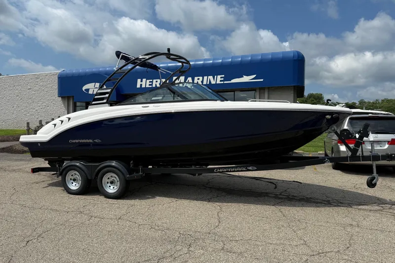 The Image of 2025 Chaparral 23 SSi boat on trailer outside marine dealership. - 0