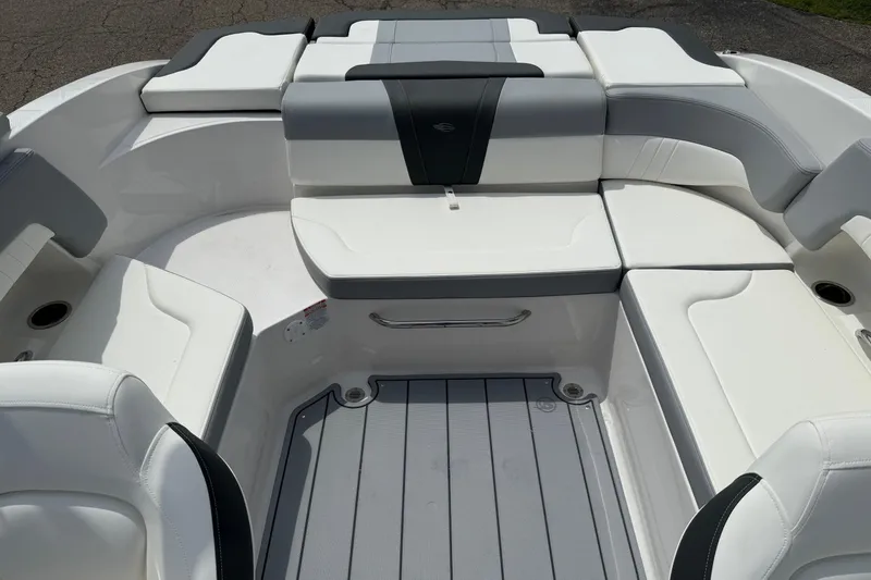 Slide: The Image of 2025 Chaparral 23 SSi boat interior with white and gray seating arrangement. - 2