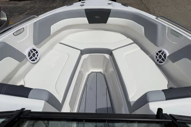 Slide: The Image of 2025 Chaparral 23 SSi boat interior with white and gray seating, featuring built-in speakers. - 3