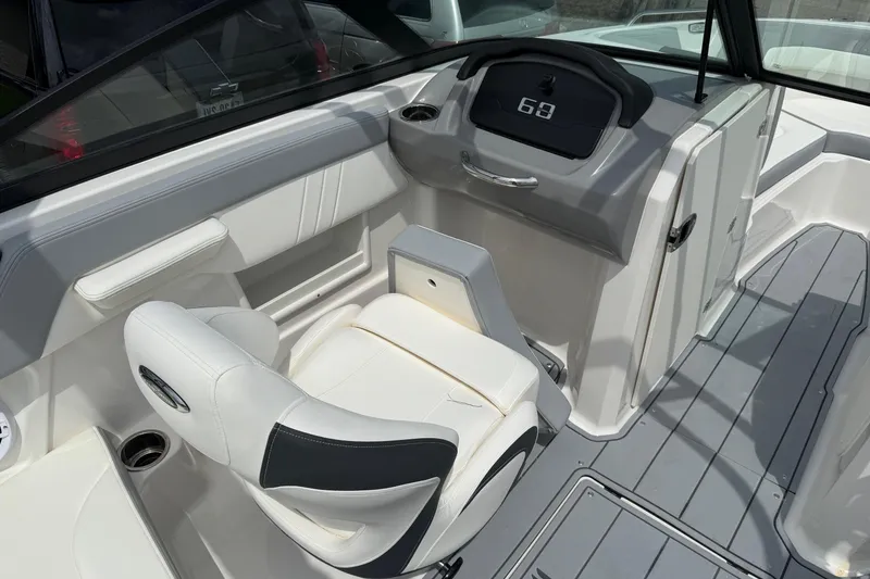 Slide: The Image of 2025 Chaparral 23 SSi boat interior with modern dashboard and comfortable seating. - 7