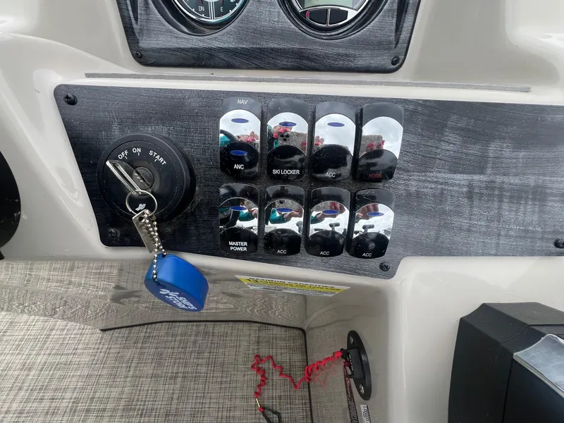 Slide: The Image of Control panel of 2022 Harris Cruiser 230 boat with ignition and switches. - 16