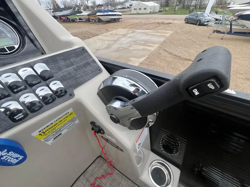 Slide: The Image of Control panel of a 2022 Harris Cruiser 230 boat with throttle lever and switches. - 17