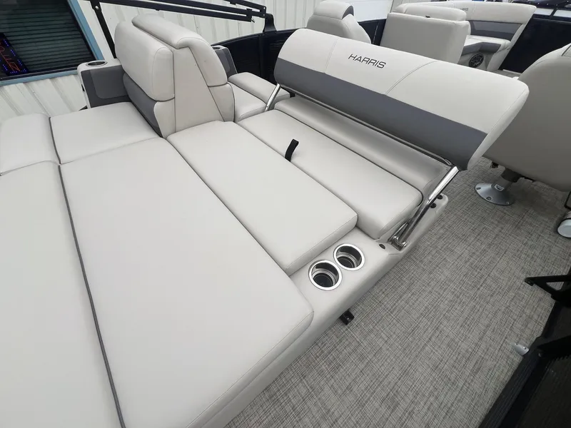Slide: The Image of 2022 Harris Cruiser 230 boat interior with plush seating and cup holders. - 21